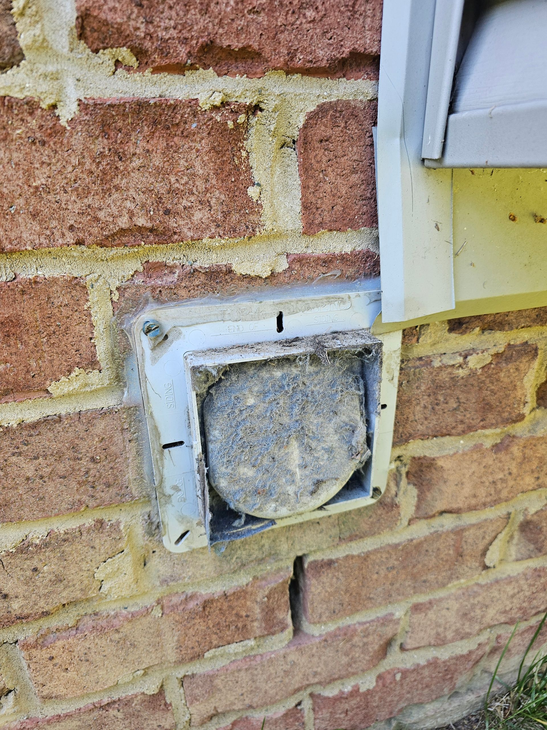 A close up of a brick wall with a hole in it.