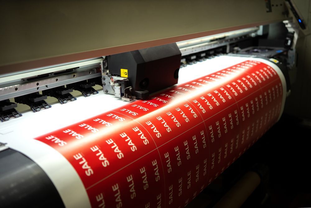 A Machine Is Printing a Large Sheet of Red Sale Stickers — Imsprint in Muswellbrook, NSW