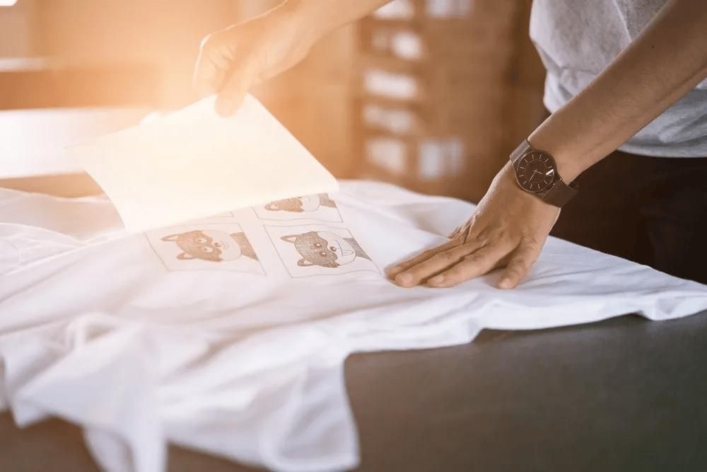 A Person Is Holding a Piece of Paper Over a White T-Shirt — Imsprint in Lake Macquarie, NSW