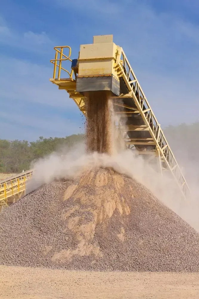 A Conveyor Belt is Pouring Sand Into a Pile of Gravel — Ostojic Group in Berrimah, NT