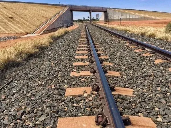 A Train Track With a Bridge in the Background — Ostojic Group in Berrimah, NT