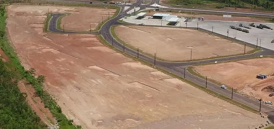 An Aerial View of a Large Dirt Field With a Road Going Through It — Ostojic Group in Berrimah, NT