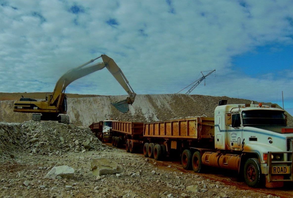 A Dump Truck is Being Loaded With Rocks by an Excavator — Ostojic Group in Berrimah, NT