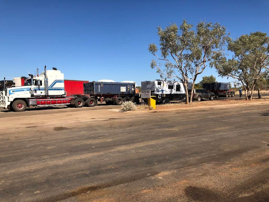 A Truck is Parked on the Side of the Road Next to a Train — Ostojic Group in Berrimah, NT