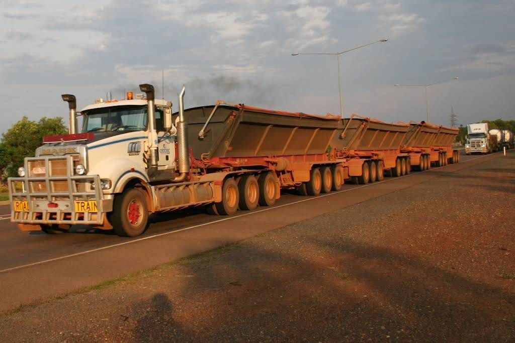 A Large Semi Truck is Driving Down a Road — Ostojic Group in Berrimah, NT