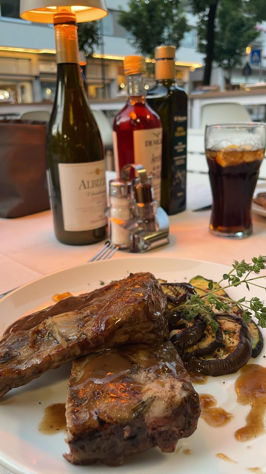 A plate of food is sitting on a table next to a glass of water.
