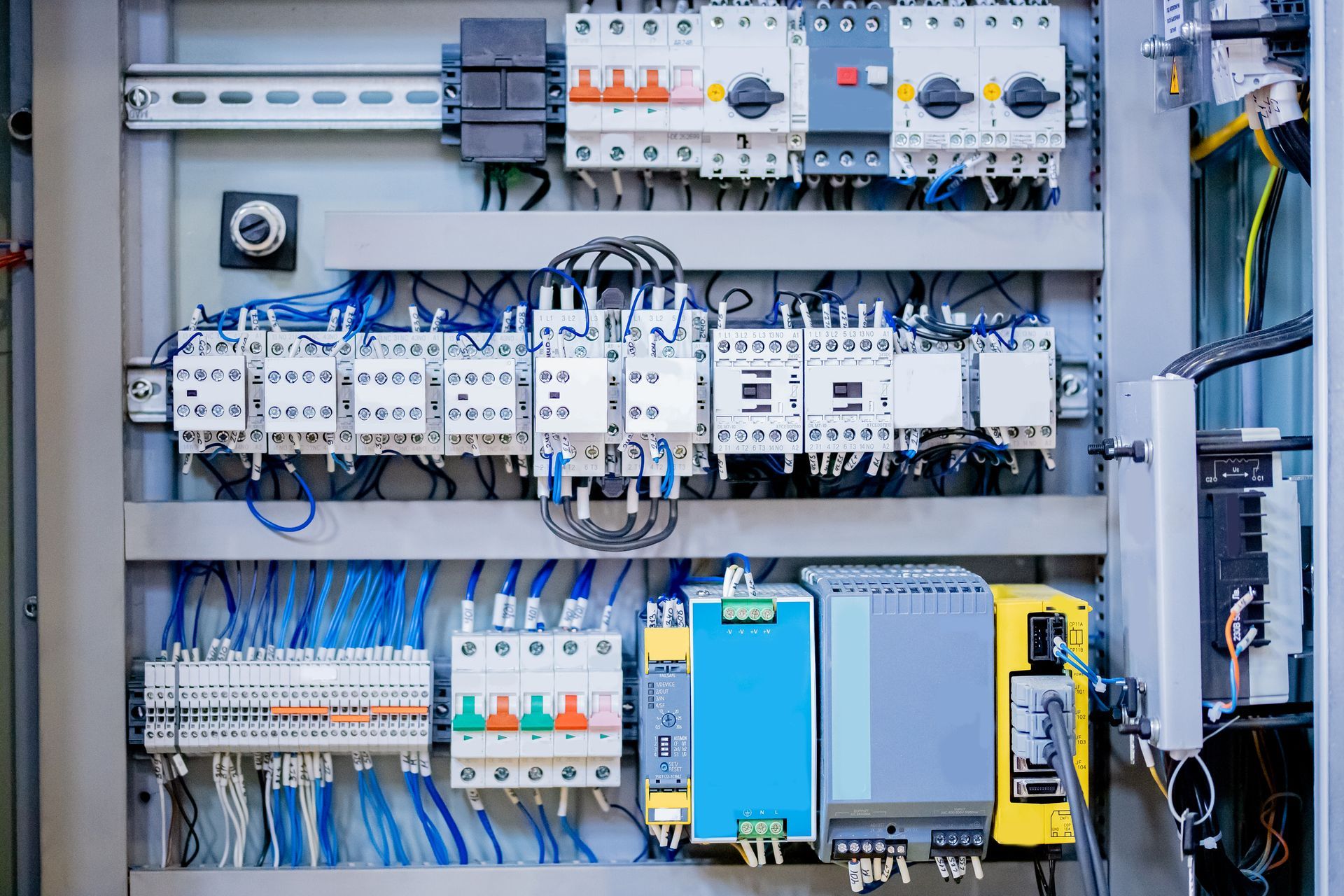 Electrical control panel with wires, circuit breakers, and other components.
