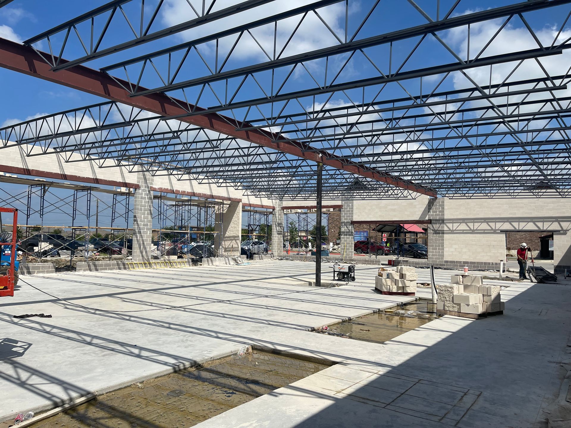 A large building under construction with a lot of metal beams.