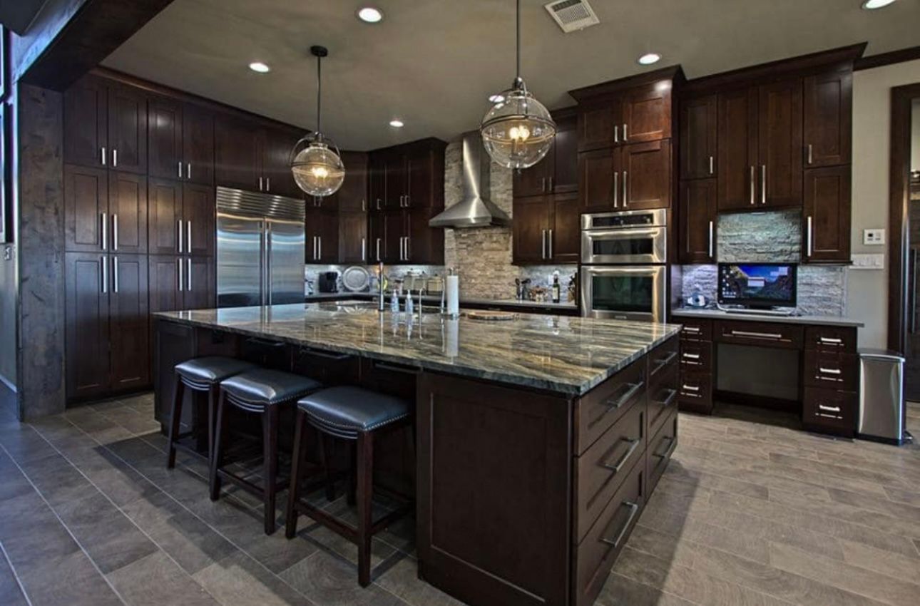 A kitchen with a large island and stools