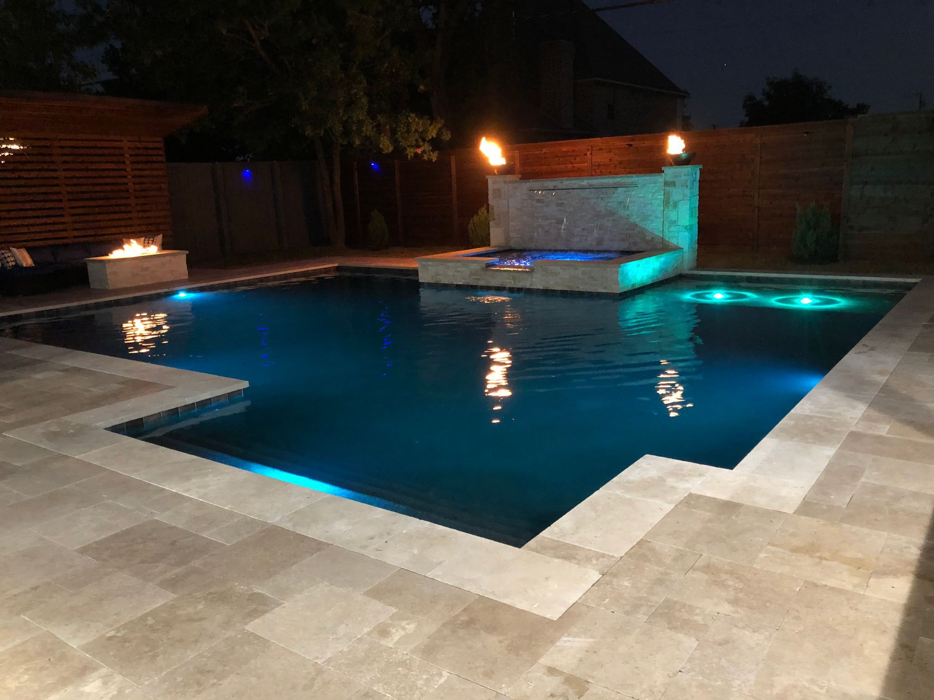 A large swimming pool is lit up at night