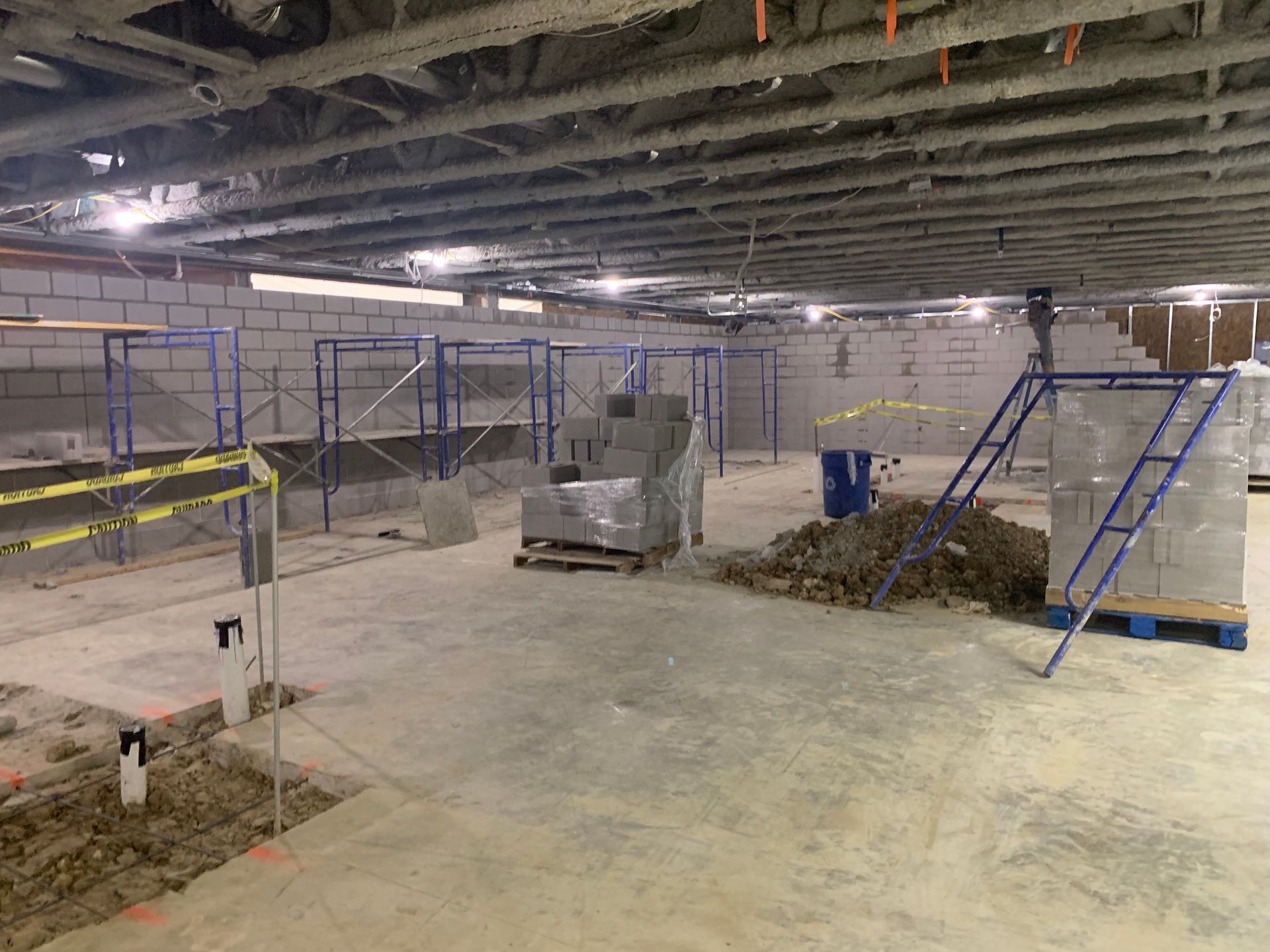 A construction site with a lot of scaffolding and bricks.