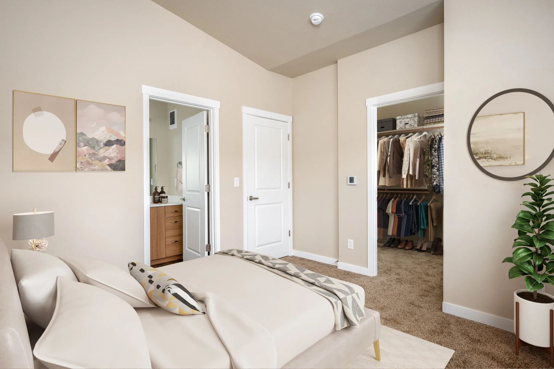 Bright beige bedroom with a bed, mirror, open closet, and wall art