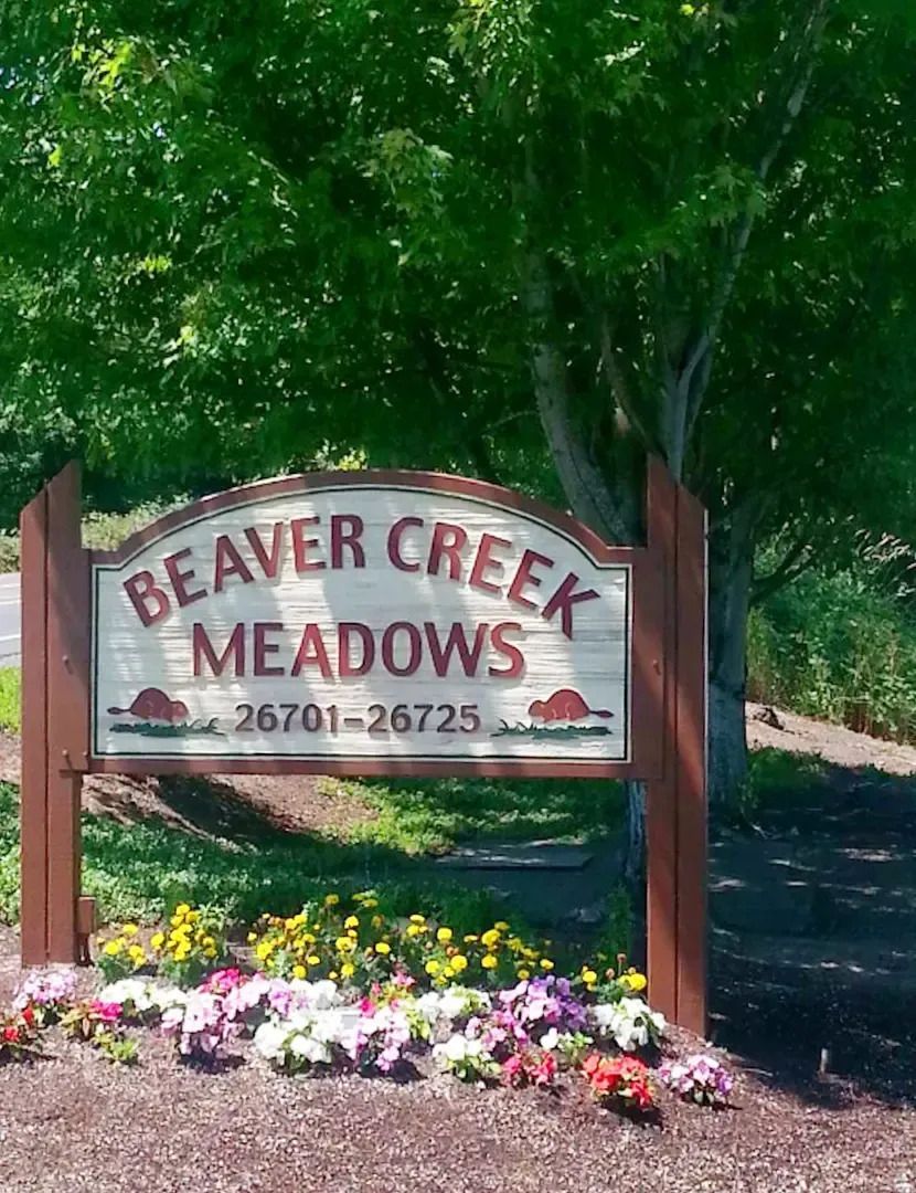 Beaver Creek Meadows sign in front of trees and flowers