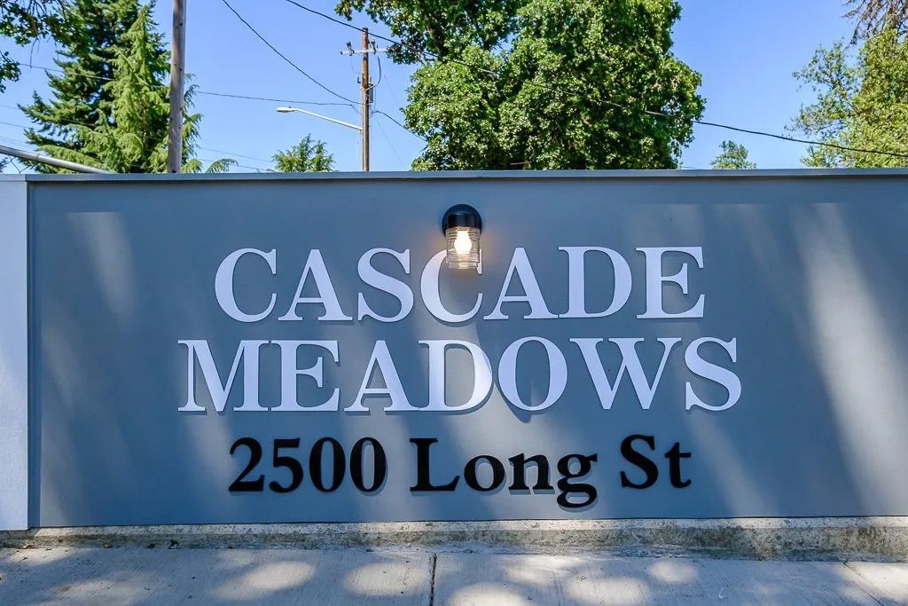 Cascade Meadows sign at 2500 Long St, white lettering on a blue background outdoors