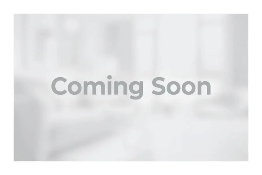 Gray “Coming Soon” text on a blurred light background