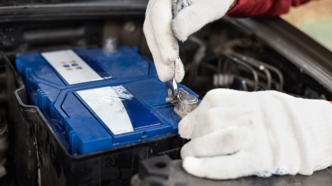 a mechanic changing a battery