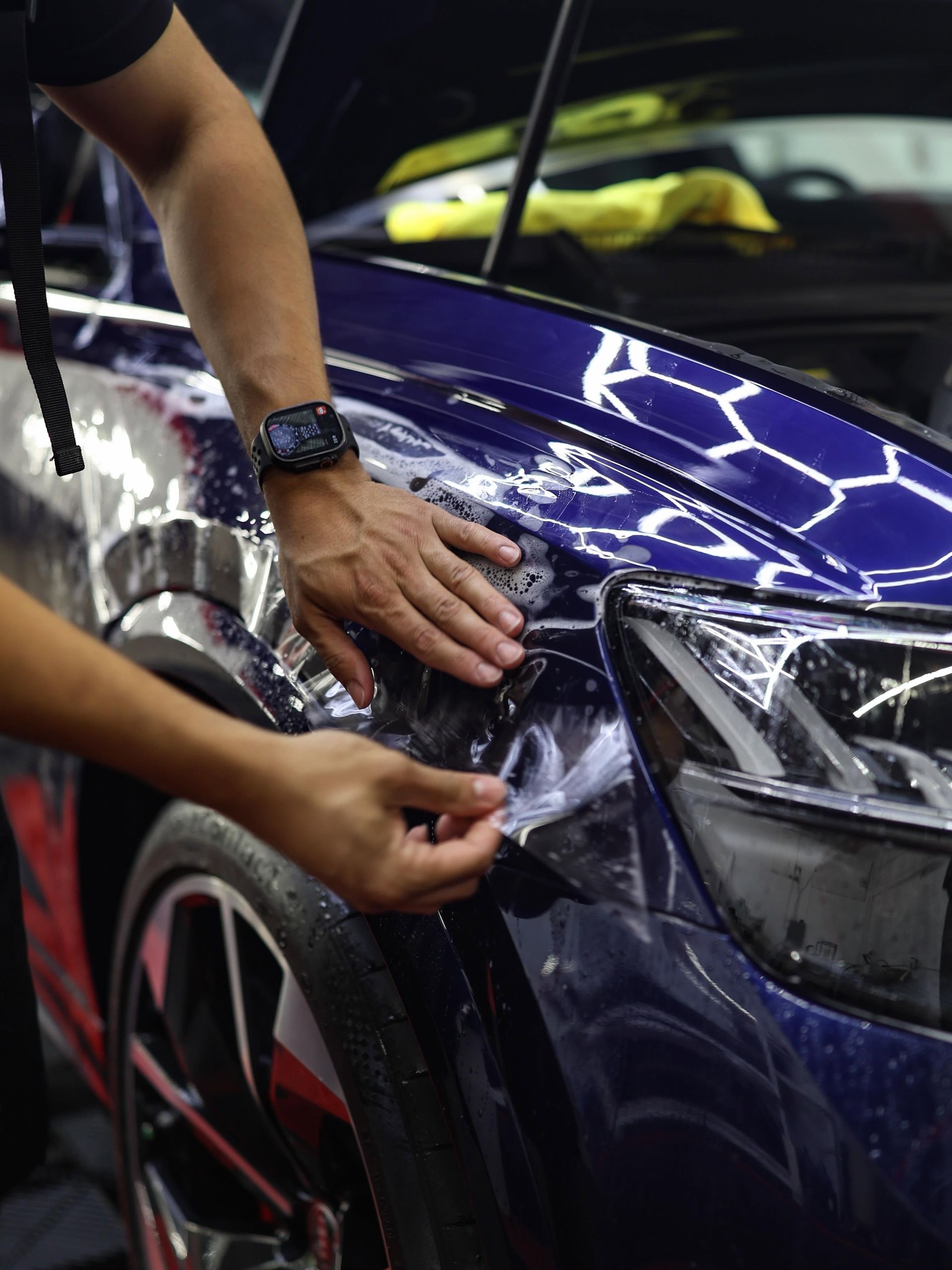PPF installation on a blue car.