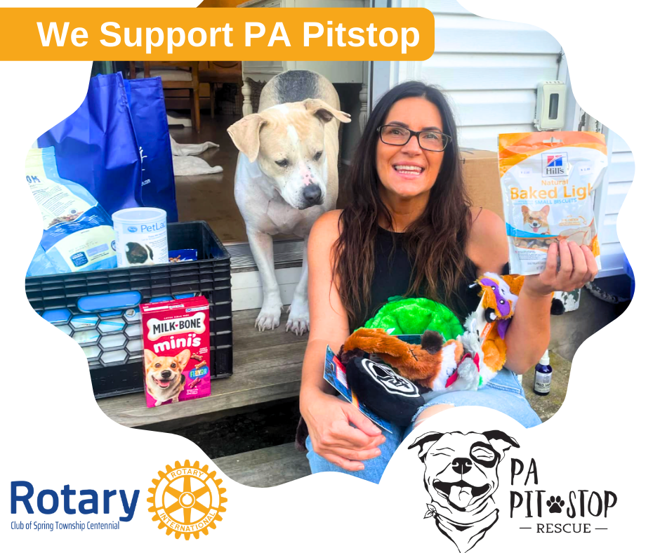 A woman is holding a bag of dog food next to a dog.