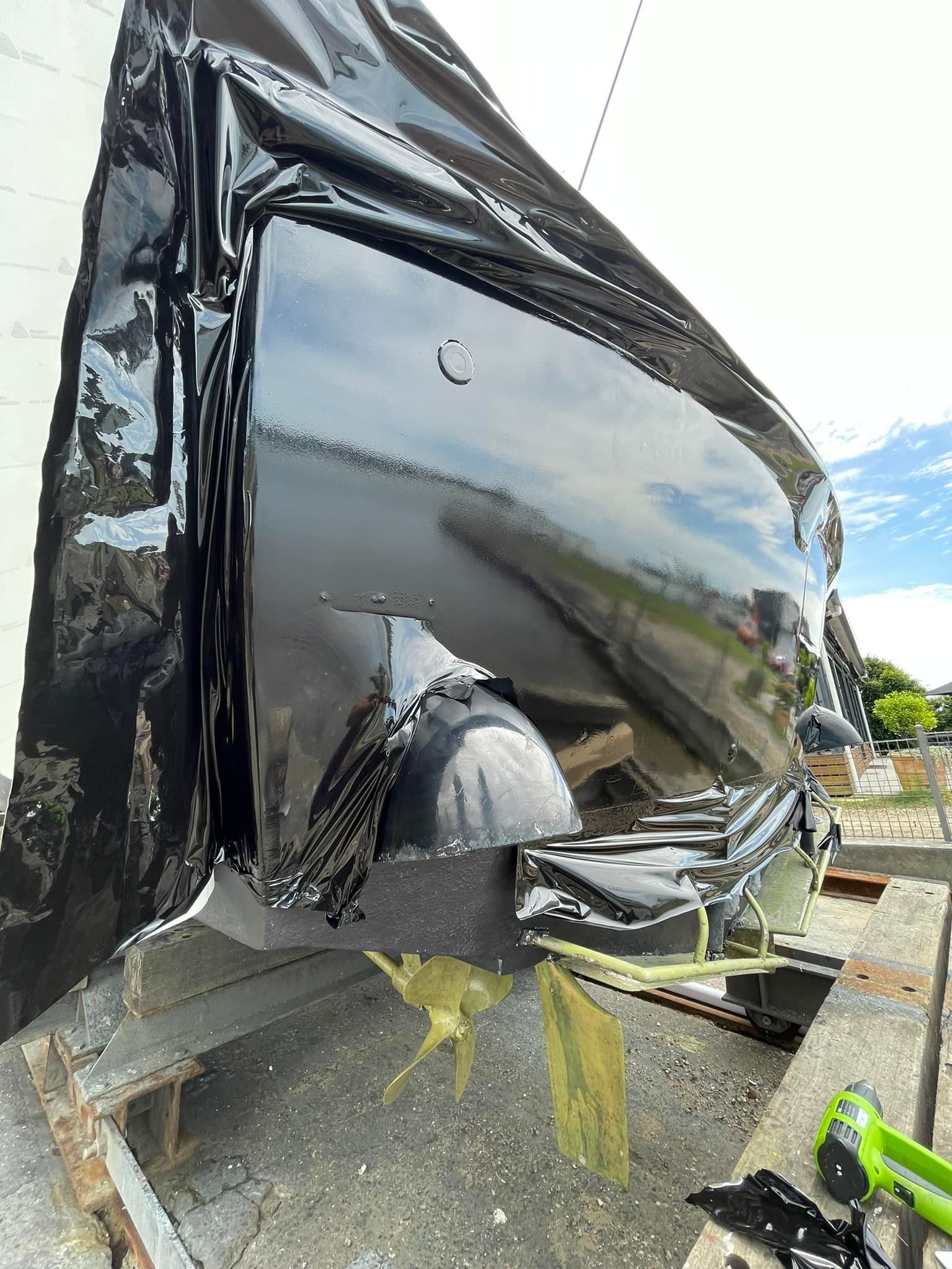 A black car is getting wrapped - Plastiglass Mid North Coast, NSW