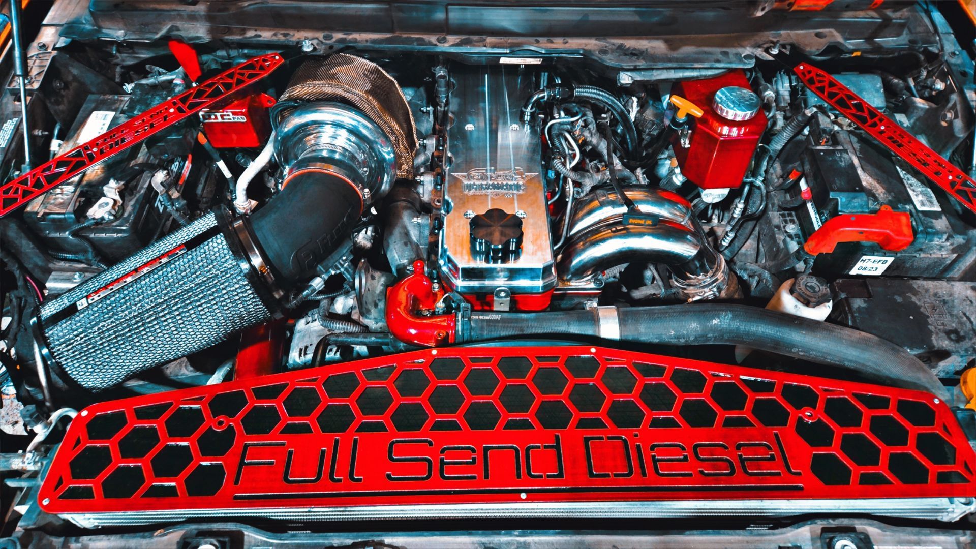 A close up of a car engine with a red grille.