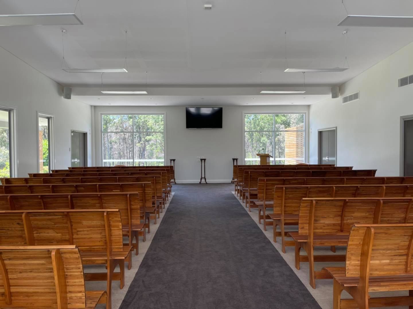 There Are Rows Of Wooden Benches In A Church — United Funeral Care In Nambucca Head, NSW