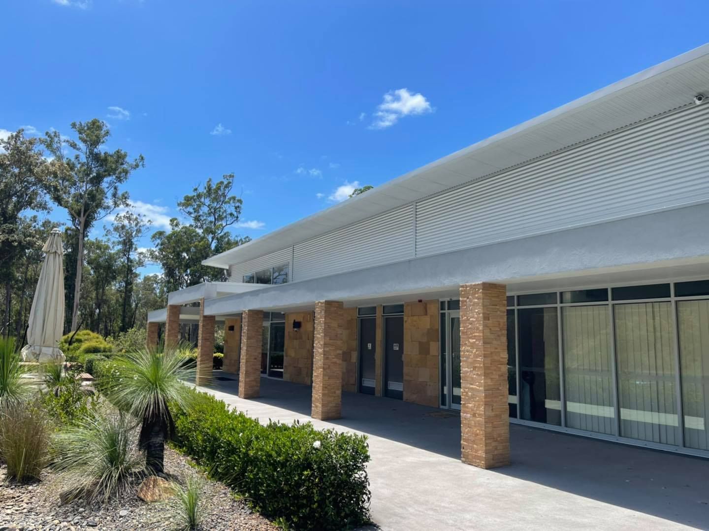 A Large Building With A Lot Of Windows And A Patio In Front Of It — United Funeral Care In Kempsey, NSW