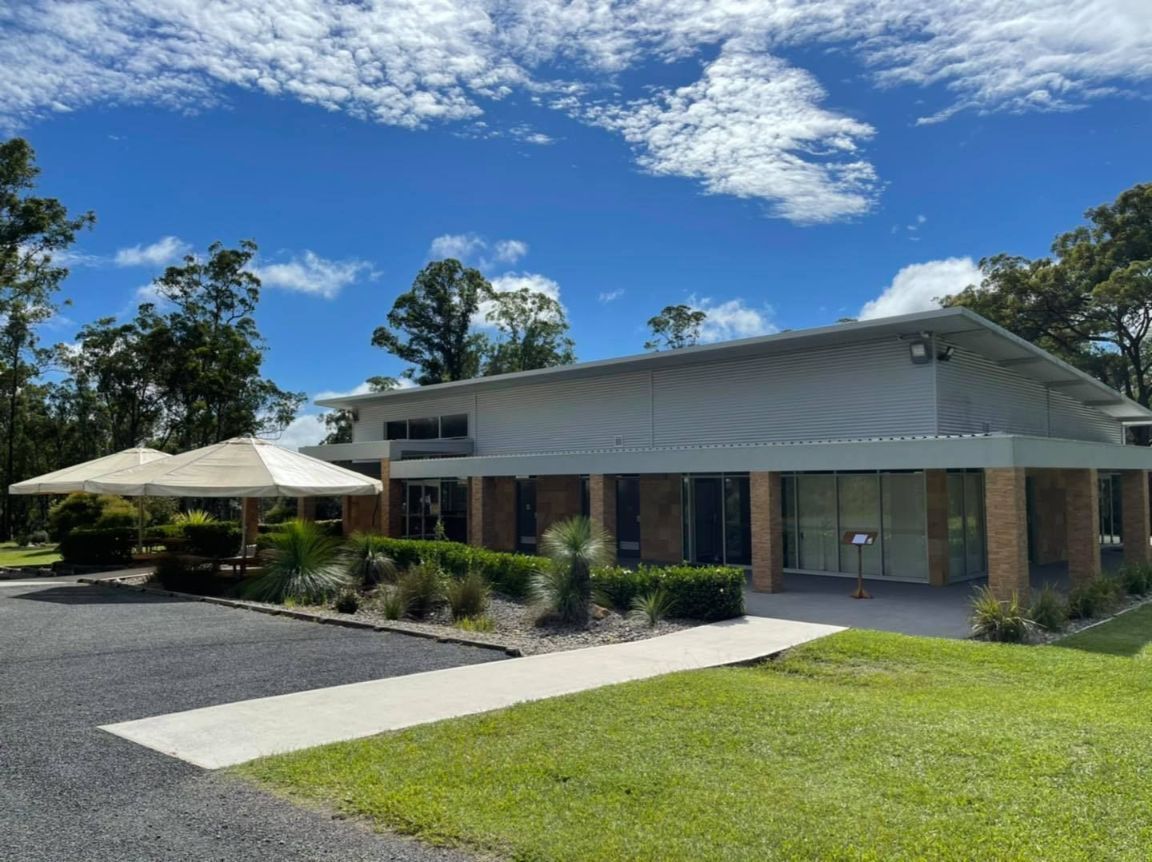 A large building with a lot of windows and a lot of grass in front of it — United Funeral Care In Kempsey, NSW