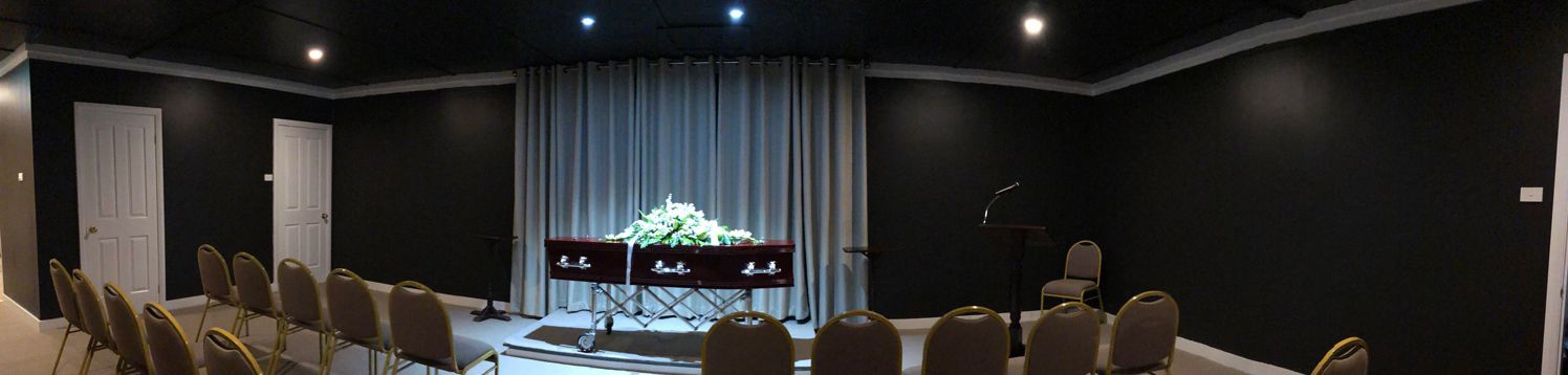 A Large Room With Rows Of Chairs And A Coffin In The Middle — United Funeral Care In Frederickton, NSW