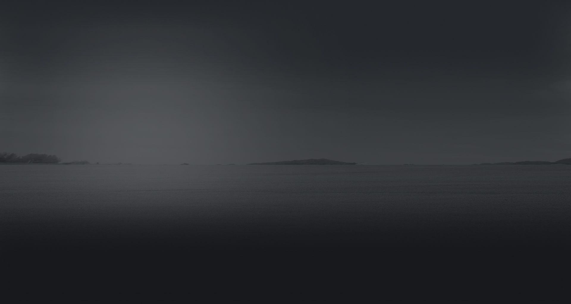 Dark, foggy seascape with distant low islands on the horizon at dusk | G3 Transmission and Auto