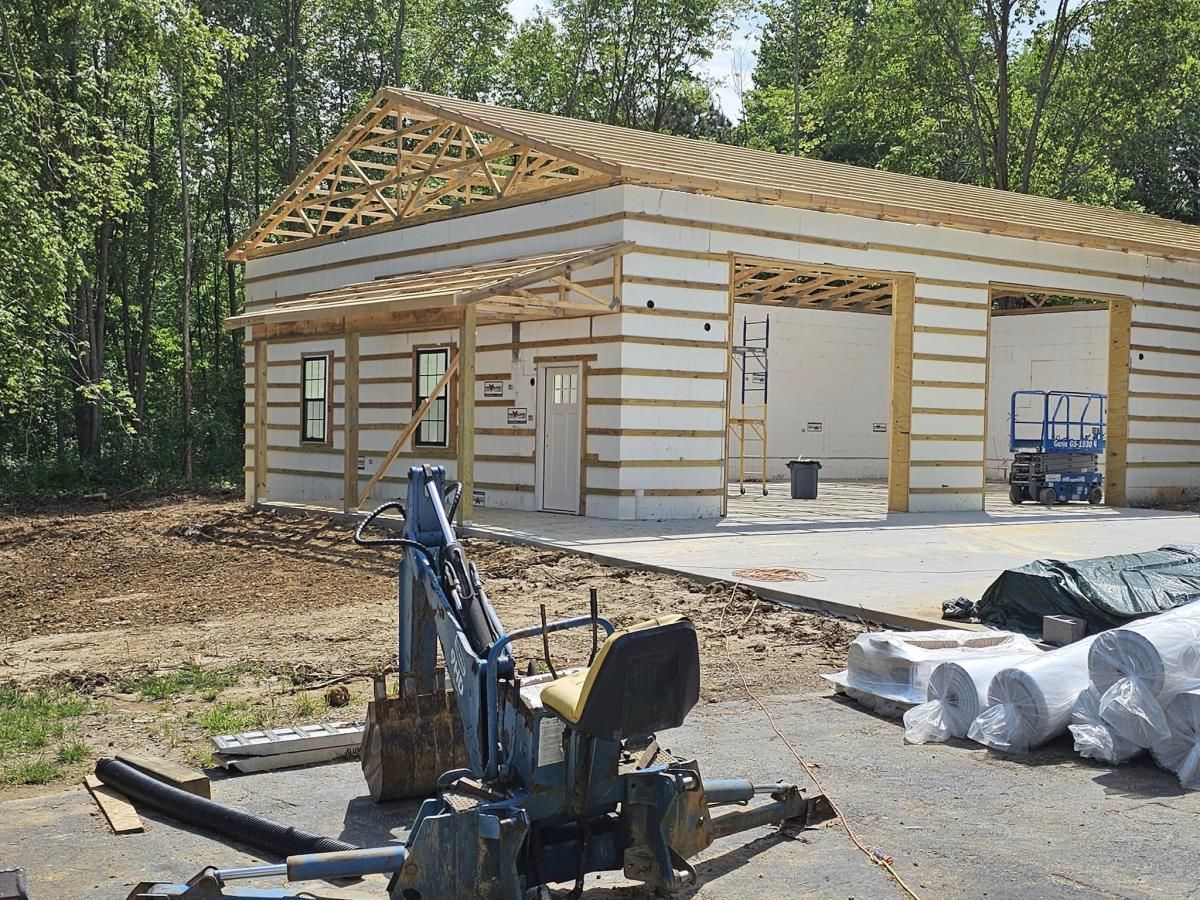 Garage construction and concrete pouring by Red Beaver Construction. Newly constructed garage with a fresh concrete pour by Red Beaver Construction, showcasing the skilled craftsmanship and quality materials used in residential projects.