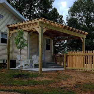 A Small House With A Wooden Pergola — Evansville, IN — Red Beaver Construction