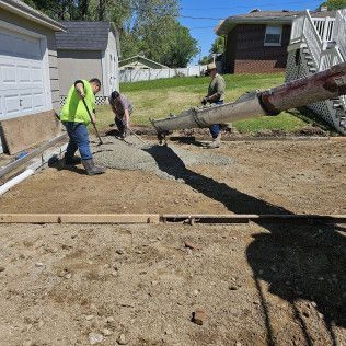 Group Of Men Are Working On A Concrete Driveway — Evansville, IN — Red Beaver Construction