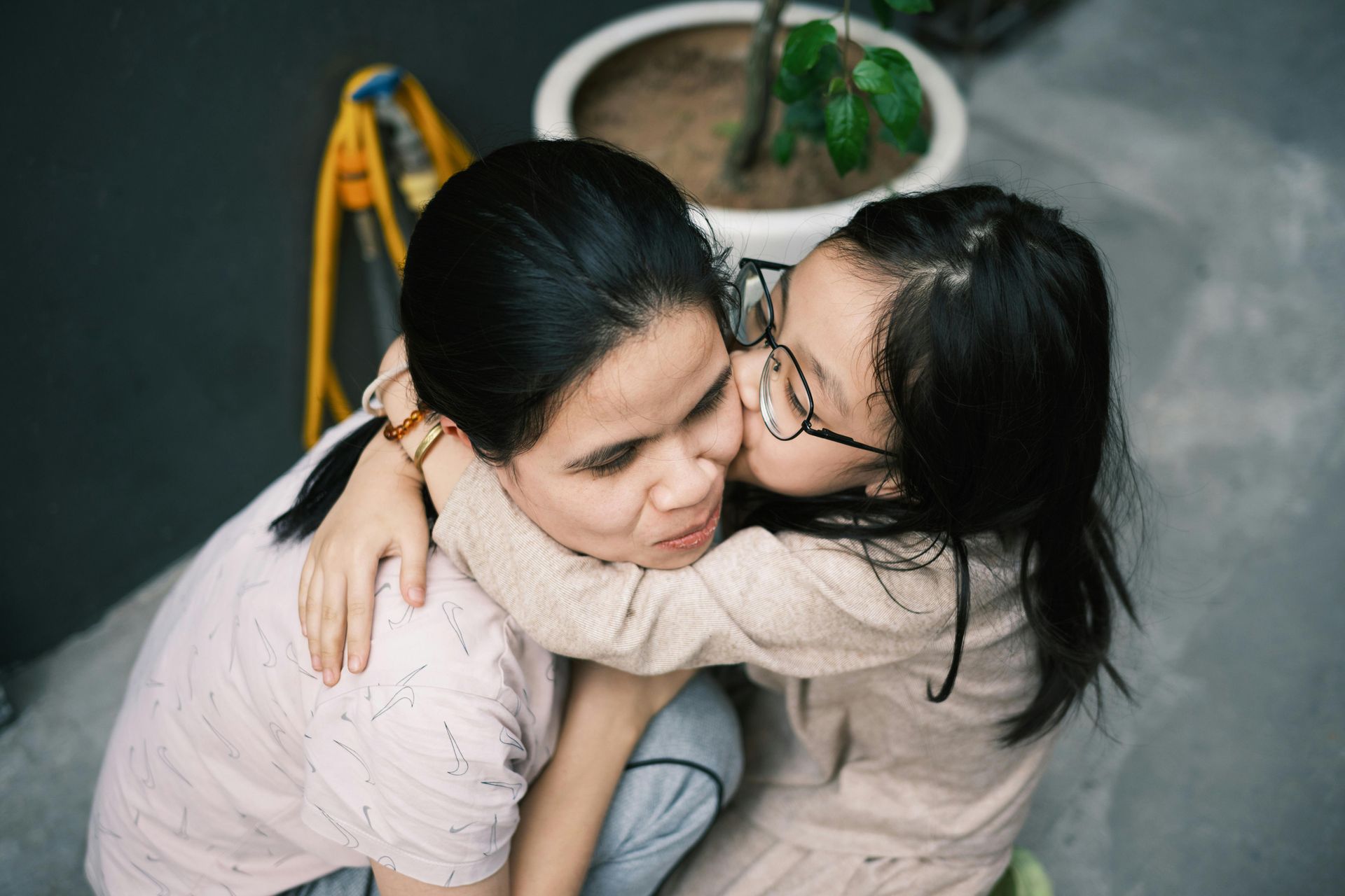 daughter kissing her mother on the cheek