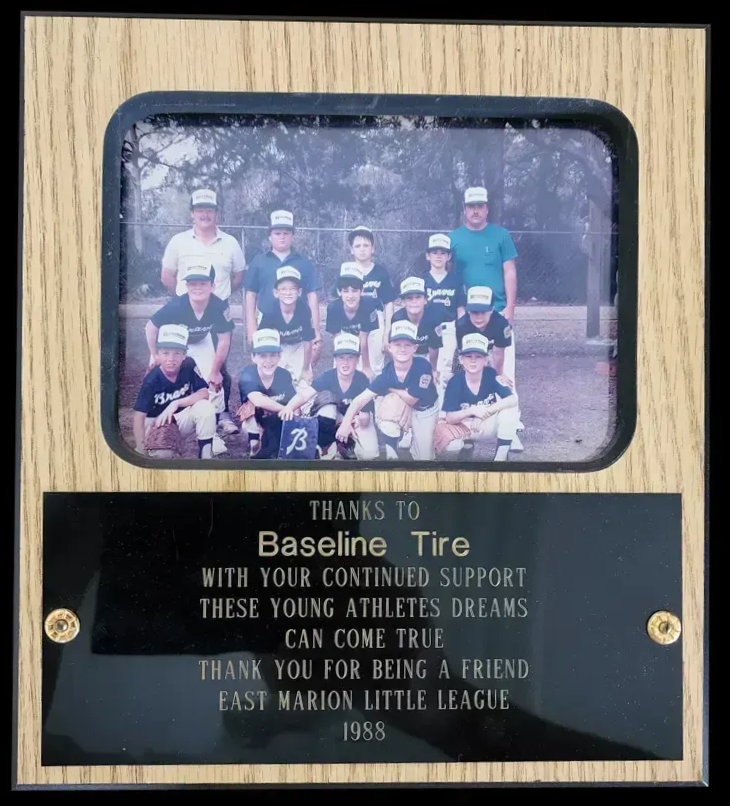 Plaque honoring Baseline Tire for supporting East Marion Little League. Includes a team photo.