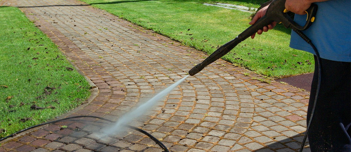 Irrigation stains on a concrete driveway in St. Augustine FL showing mineral buildup before professional pressure washing