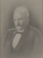 Blurred sepia portrait of an older man in a suit and bow tie, facing slightly left.