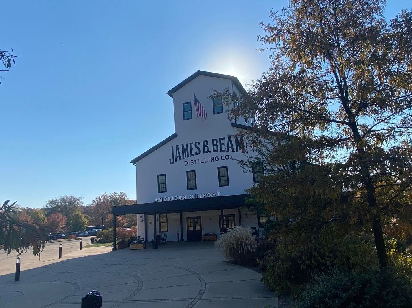 James Beard building with a white facade, blue roof, and autumn trees under a clear sky