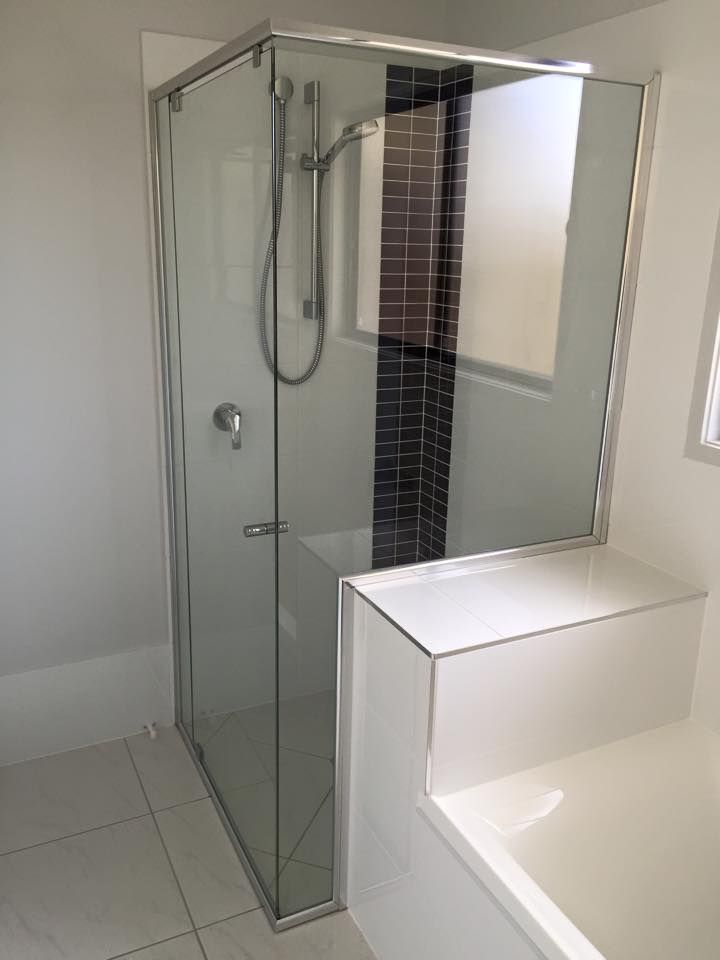 A Bathroom With a Shower Stall and a Bathtub — Frameless Shower Installations In Noosa, QLD