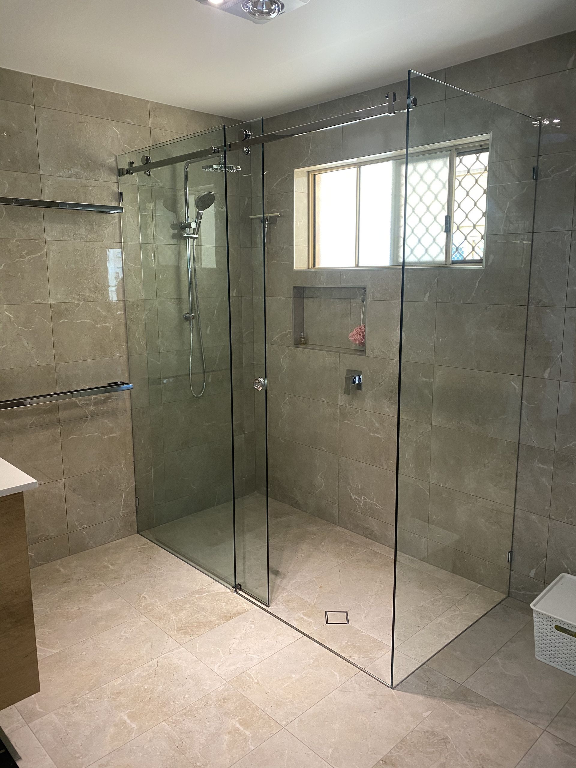 A Bathroom With a Walk in Shower and a Toilet — Frameless Shower Installations in Maroochydore, QLD 