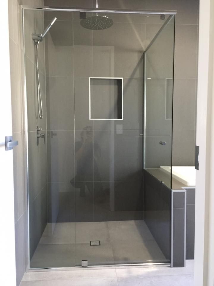 A Bathroom With a Walk in Shower and a Sink — Frameless Shower Installations In Noosa, QLD