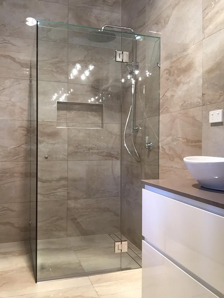 A Bathroom With a Walk in Shower and a Sink — Frameless Shower Installations in Maroochydore, QLD 
