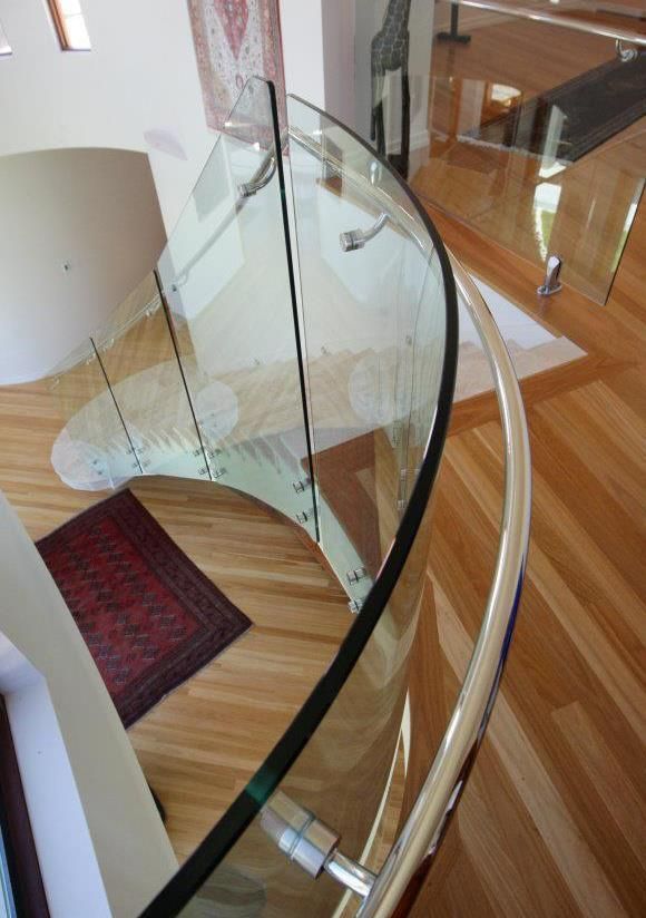 A Kitchen With White Cabinets and Black Counter Tops — Frameless Shower Installations In Maroochydore, QLD