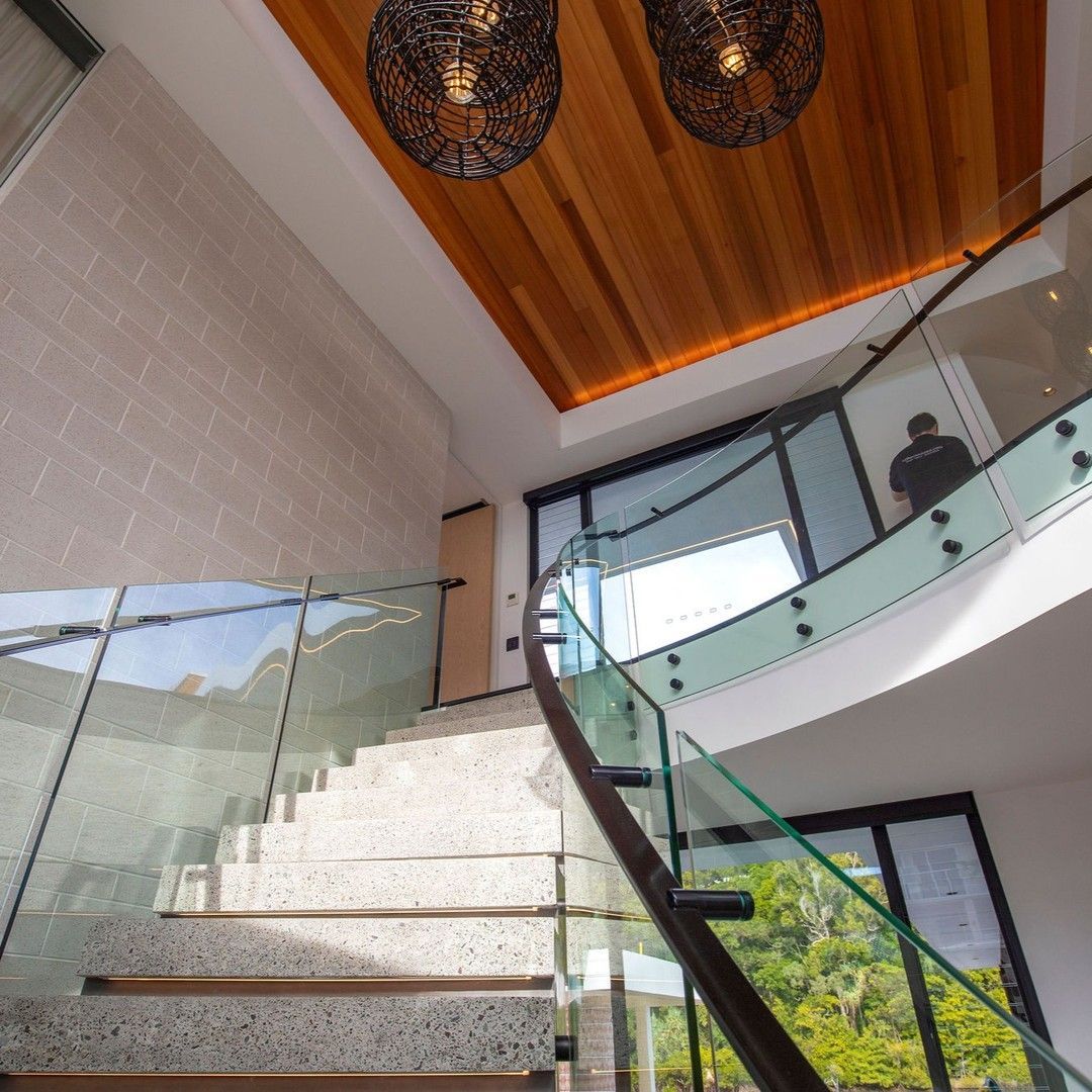 Spiral Staircase With Glass Railing, Wood Ceiling, and Pendant Lights — Frameless Shower Installations in Maroochydore, QLD