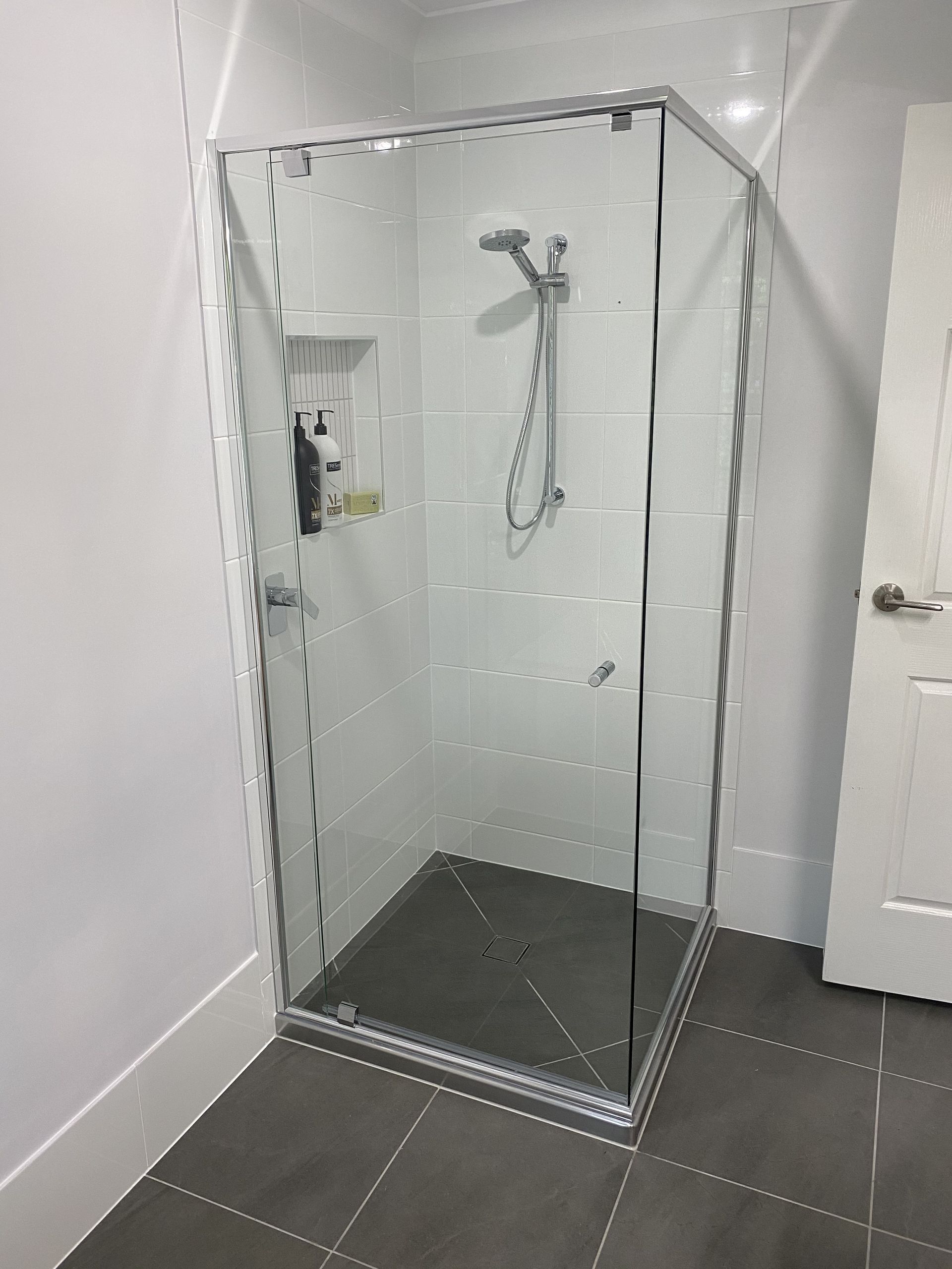 A Bathroom With a Bathtub and a Walk in Shower — Frameless Shower Installations In Mooloolaba, QLD