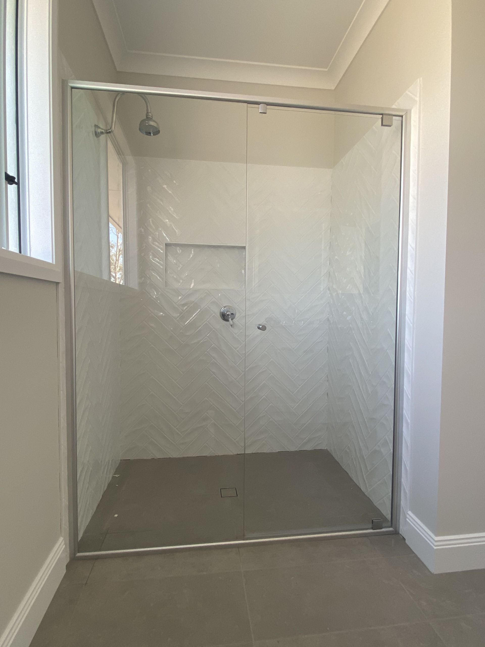 A Bathroom With a Walk in Shower and a Sink — Frameless Shower Installations In Maroochydore, QLD