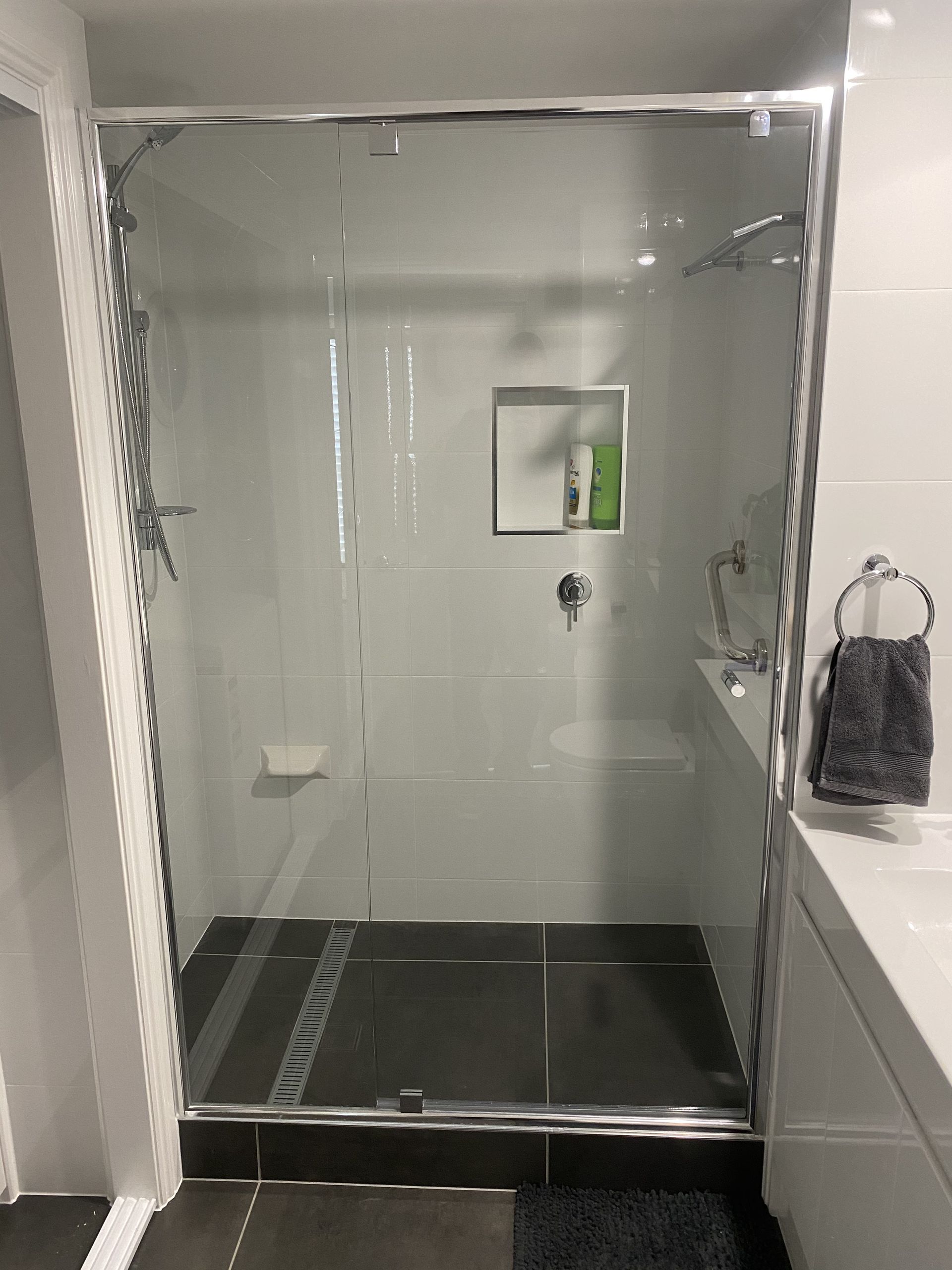 A Shower Stall With a Black Frame and Clear Glass — Frameless Shower Installations In Caloundra, QLD