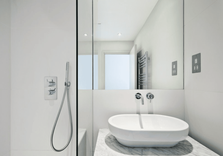 A Bathroom With A Sink , Shower And Mirror  — Frameless Shower Installations In Maroochydore, QLD
