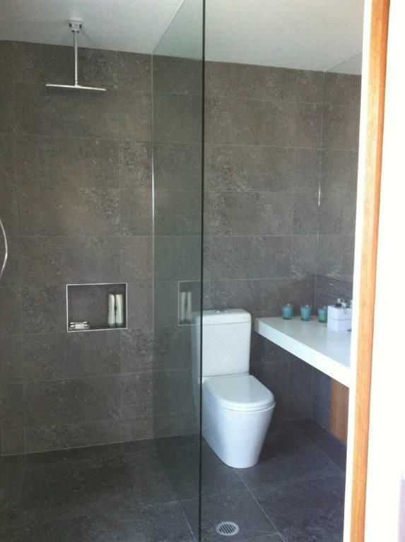 A Bathroom With a Toilet and a Walk in Shower — Frameless Shower Installations In Maroochydore, QLD
