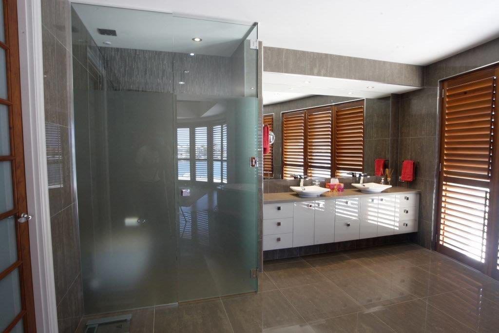 A Bathroom With Two Sinks and a Walk in Shower — Frameless Shower Installations In Maroochydore, QLD