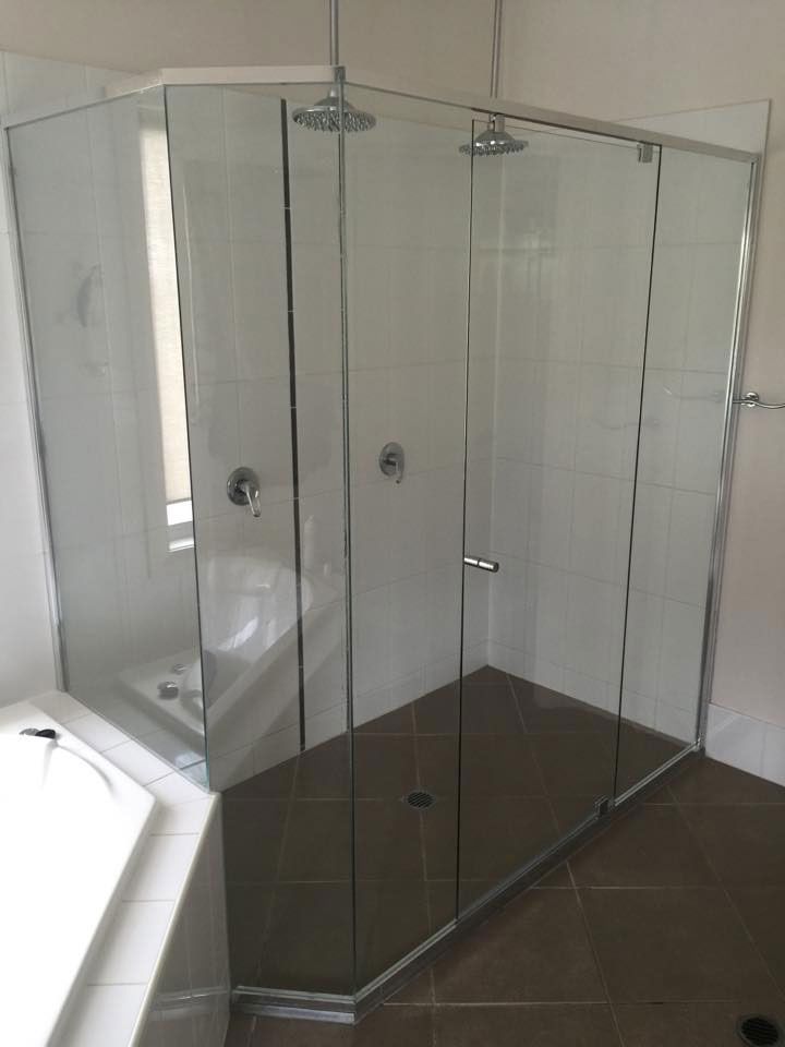 A Kitchen With Red Cabinets and a Stove Top Oven — Frameless Shower Installations In Maroochydore, QLD